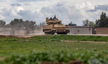 A US armored military vehicle drives on the outskirts of Rumaylan in Syria's northeastern Hasakeh province