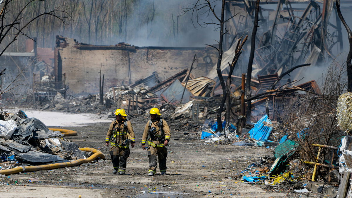 <i>Michael Conroy/AP</i><br/>Firefighters walk out of the site of the recycling plant fire in Richmond