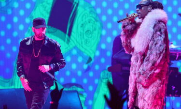 Eminem and Snoop Dogg perform onstage at the 2022 MTV VMAs. The performance included a video of them as BAYC characters.