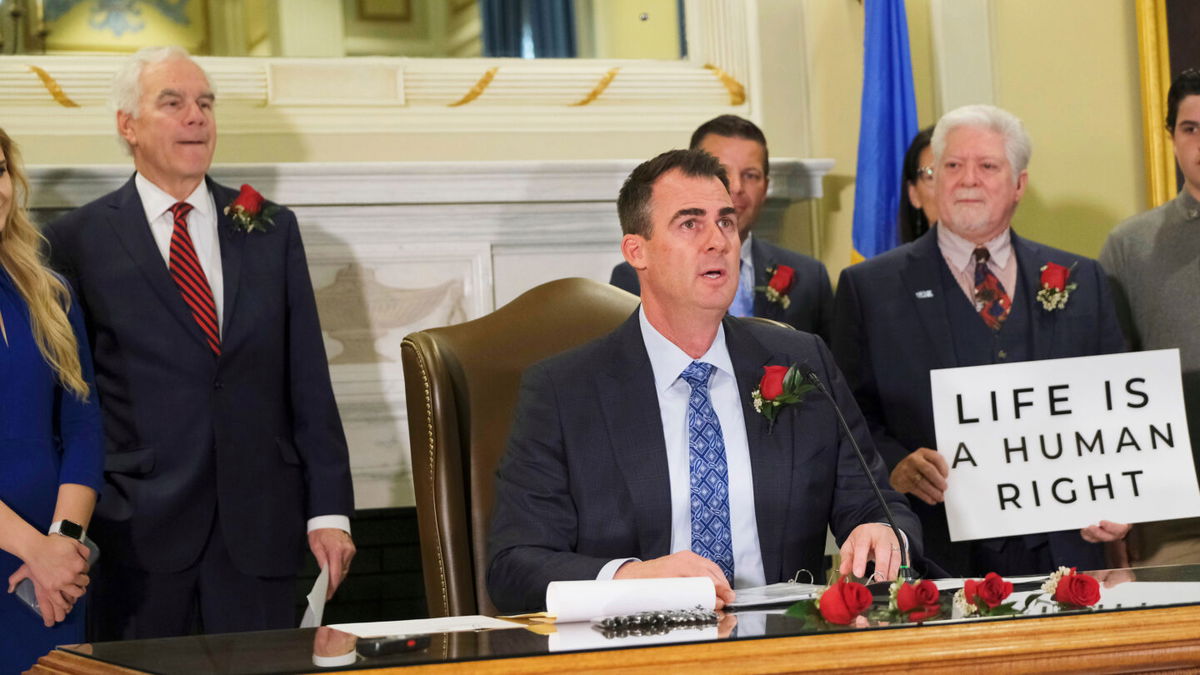 <i>Doug Hoke/The Oklahoman/USA Today Network</i><br/>Gov. Kevin Stitt signs Senate Bill 612 on April 12