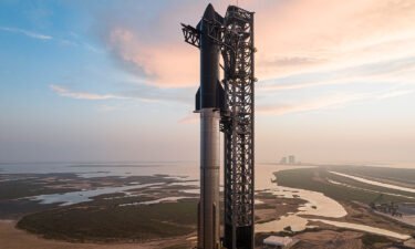 The Starship rocket sits on the SpaceX Starbase in Boca Chica