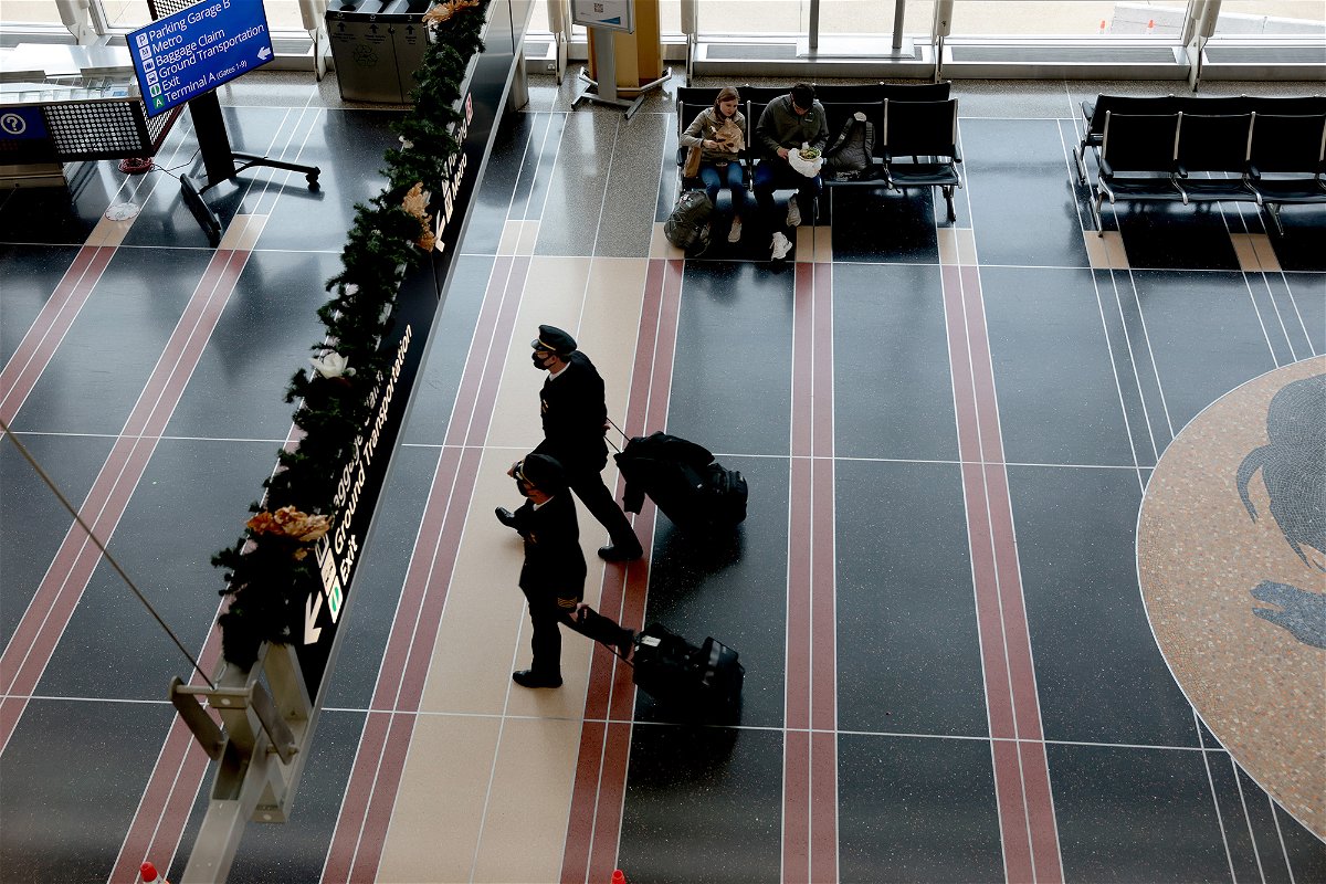 <i>Anna Moneymaker/Getty Images</i><br/>US airlines are about to be hit with a 'tsunami' of pilot retirements. Pilots walk through the Ronald Reagan Washington National Airport in 2021 in Arlington