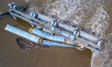 Two barges are seen stuck in the Ohio River; one has been removed