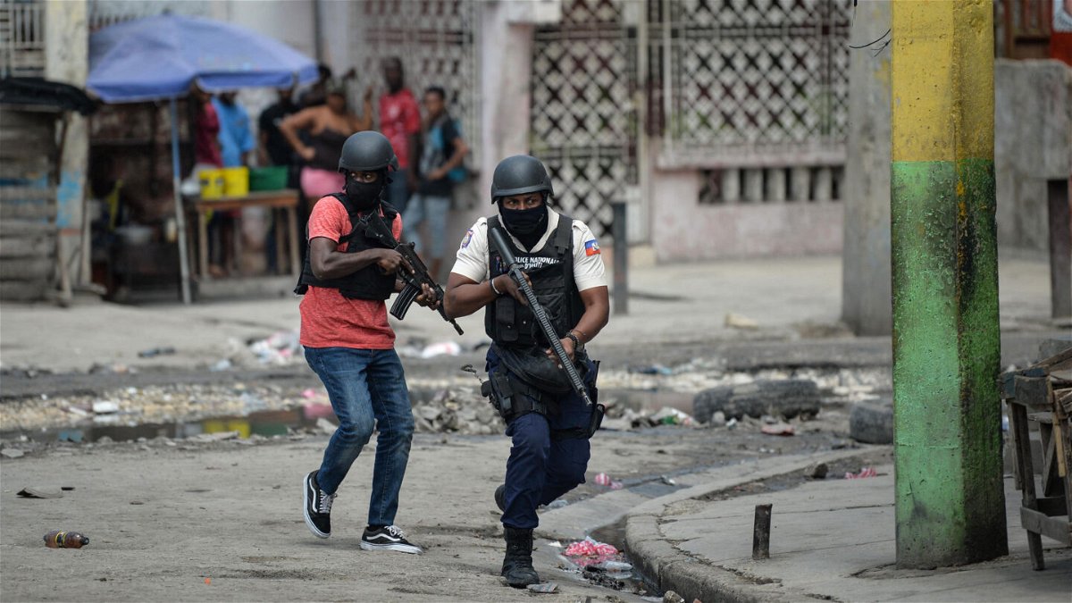 <i>Richard Pierrin/AFP/Getty Images</i><br/>Police officers patrol a neighborhood amid gang-related violence in downtown Port-au-Prince on April 25.