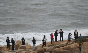 Rising sea levels on China's coastline pose a serious threat to coastal cities such as the financial hub of Shanghai. Pictured are tourists on the coastline of Pingtan island in China's southeastern province of Fujian on April 7.