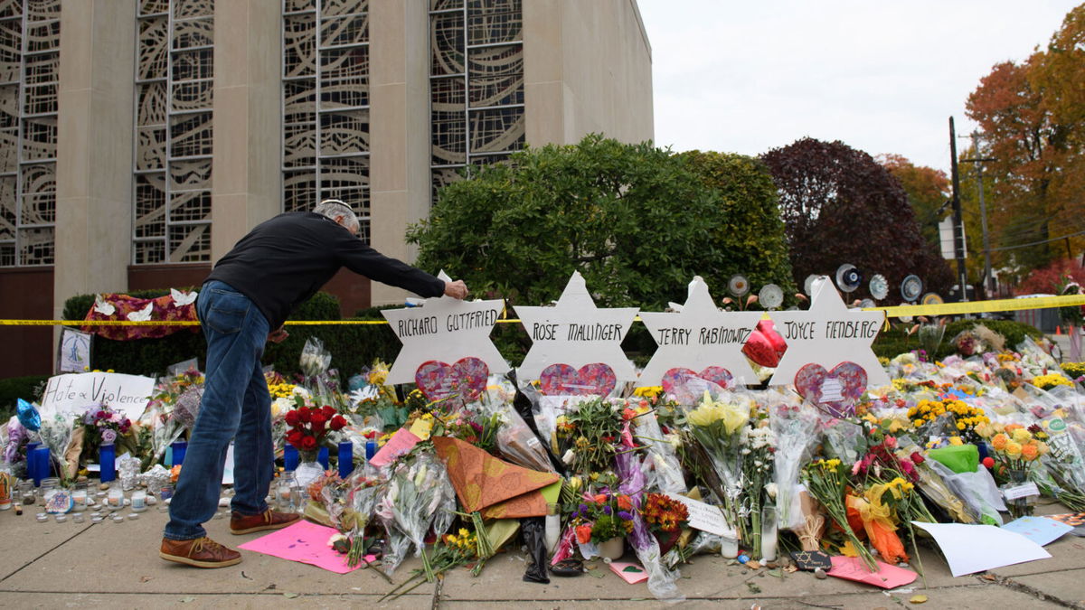 <i>Jeff Swensen/Getty Images</i><br/>Mourners visit a memorial outside the Tree of Life synagogue on October 31