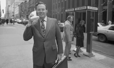 Motorola vice president John F. Mitchell shows how easily company's newest product-Dyna T-A-C Portable Radio Telephone System can be used in New York