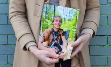 Vienna holds a photo of her slain partner