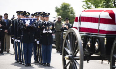 Soldiers from the Old Guard with a flag and urn holding remains of Isaac Hart.