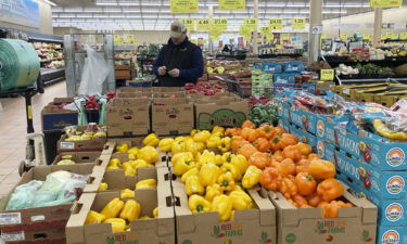 A man looks at his mobile phone while shopping at a grocery store in Buffalo Grove