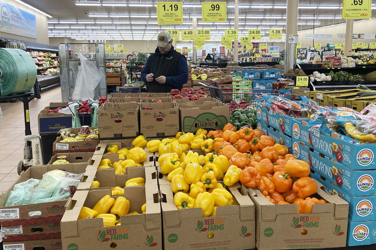 <i>Nam Y. Huh/AP</i><br/>A man looks at his mobile phone while shopping at a grocery store in Buffalo Grove