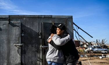 Tracy Harden (right) hugs Barbara Nell McReynolds-Pinkins near the walk-in cooler where they and seven others took shelter as a tornado destroyed Harden's restaurant in Rolling Fork