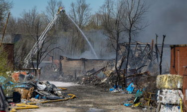 Firefighters pour water on an industrial fire in Richmond on Wednesday.