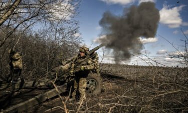 Ukrainian servicemen fire at Russian positions with a 105mm howitzer in the region of Donbas