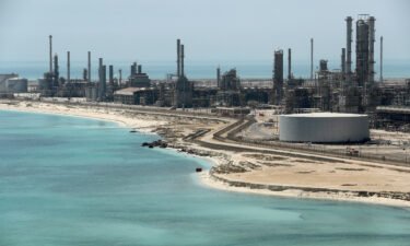 Oil prices surged Monday after OPEC+ producers unexpectedly announced that they would cut output. Pictured is Ras Tanura oil refinery in Saudi Arabia