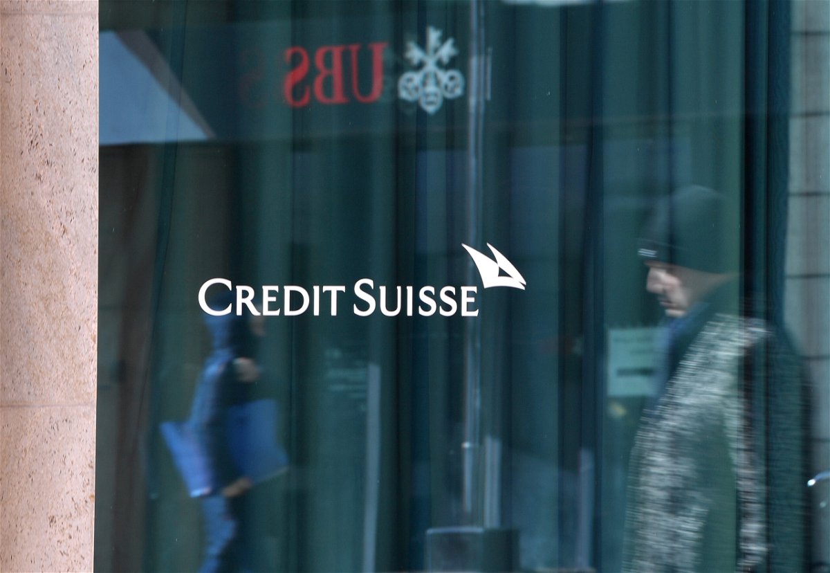 <i>Lian Yi/Xinhua/Getty Images</i><br/>Passersby are reflected in the window of a building of Credit Suisse in Geneva