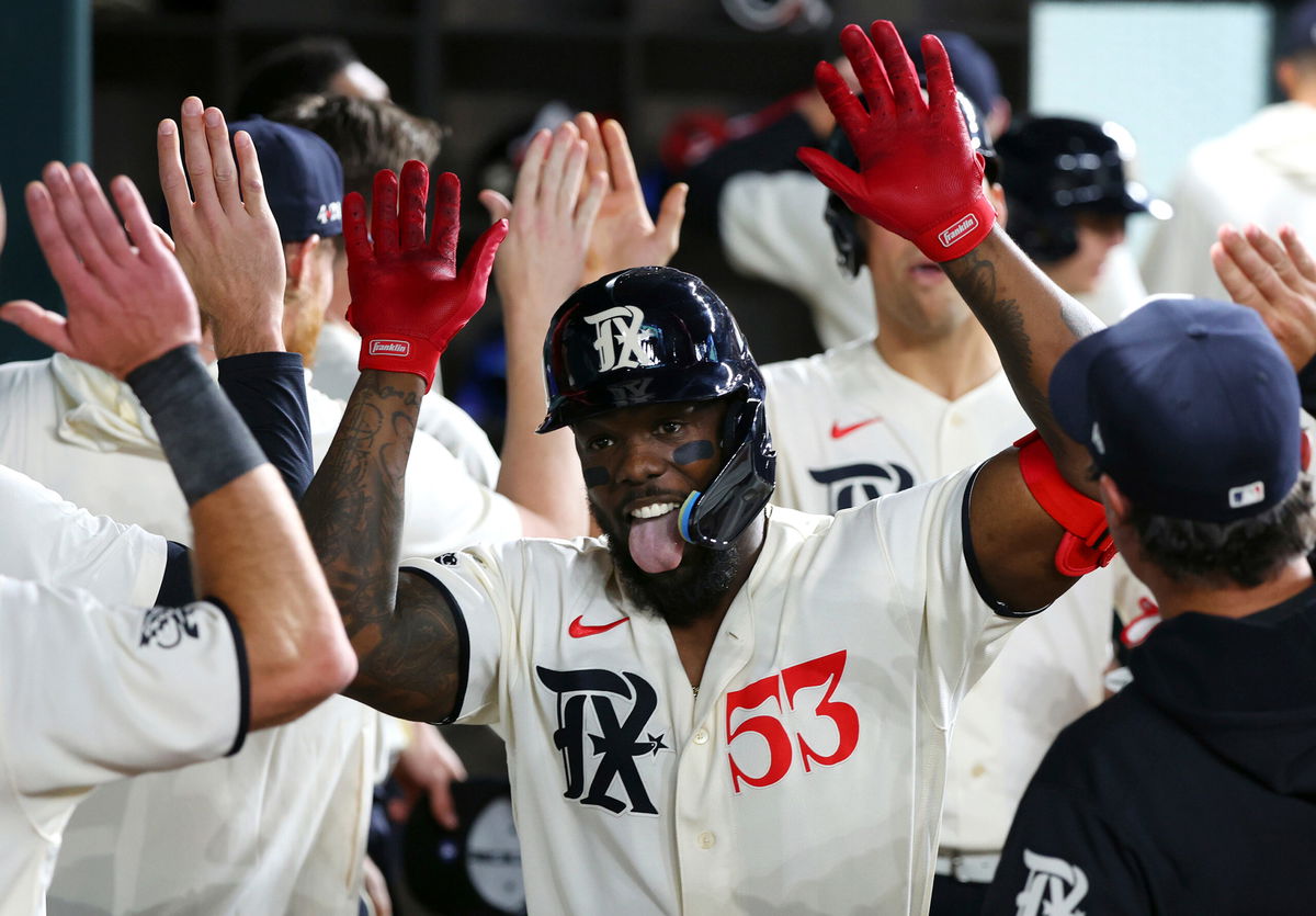 <i>Richard W. Rodriguez/AP</i><br/>Adolis García celebrates in the dugout after his third home run of the night.