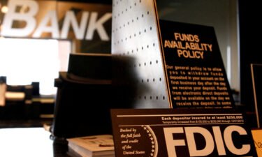 Signs explaining the FDIC and banking policies on the counter of a bank in Colorado.