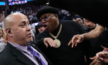 Earl 'E-40' Stevens talks to security personnel before being escorted from courtside during Game 1 of the Western Conference first round playoffs between the Golden State Warriors and Sacramento Kings on April 15.