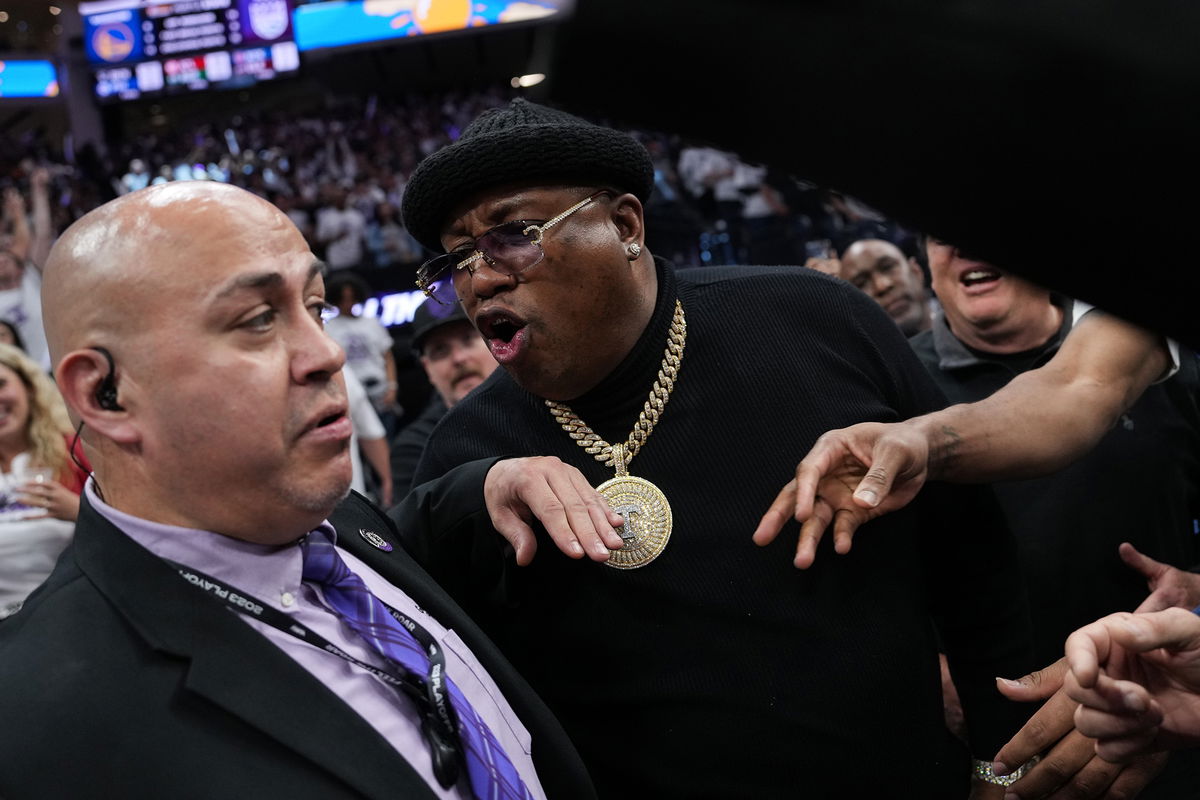 <i>Loren Elliott/Getty Images</i><br/>Earl 'E-40' Stevens talks to security personnel before being escorted from courtside during Game 1 of the Western Conference first round playoffs between the Golden State Warriors and Sacramento Kings on April 15.