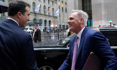 US House Speaker Kevin McCarthy is greeted by John Tuttle