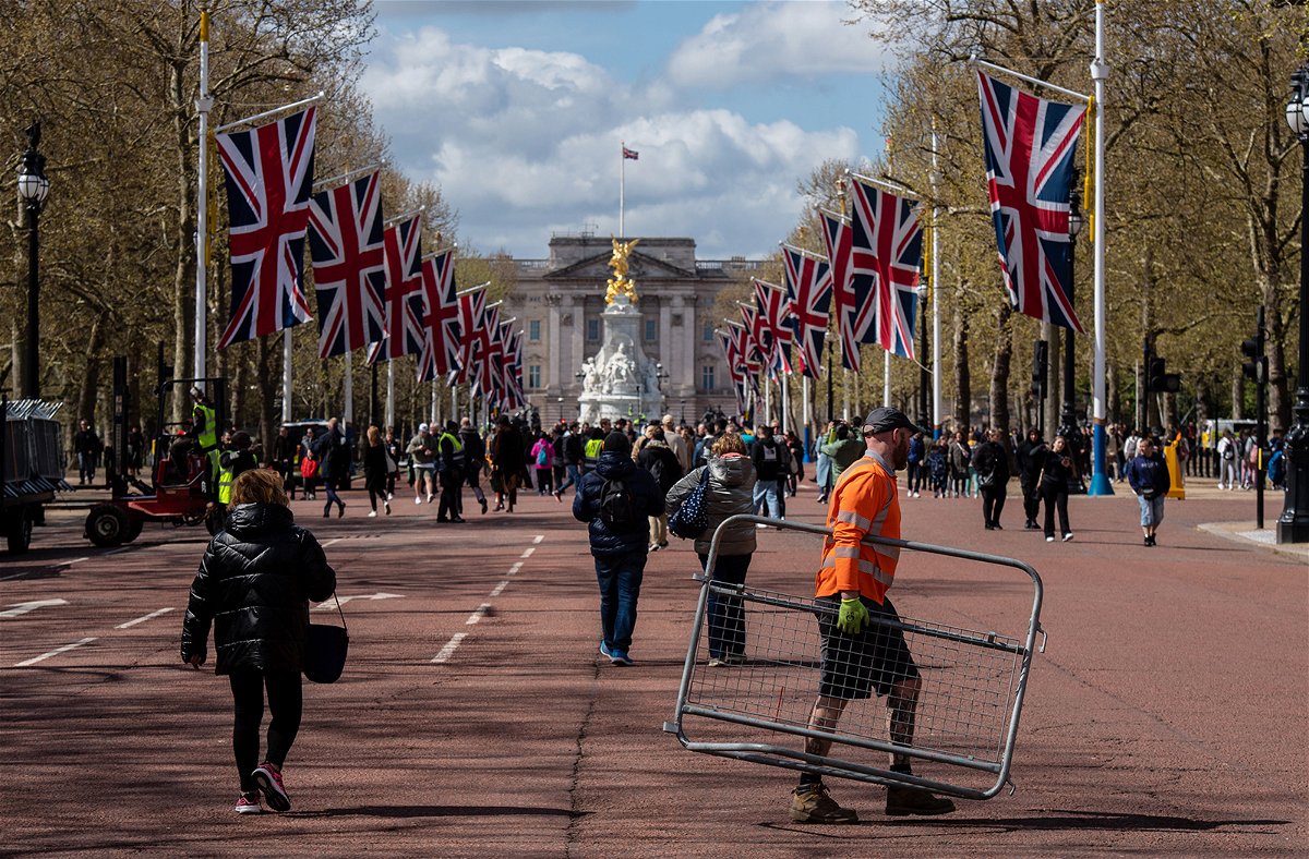 <i>Chris J. Ratcliffe/Bloomberg/Getty Images</i><br/>A worker carries a crowd control barrier on The Mall as preparations for the coronation begin.