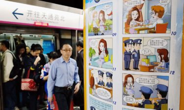 A comic strip poster warning of foreign spies is displayed at a subway station in Beijing on April 22