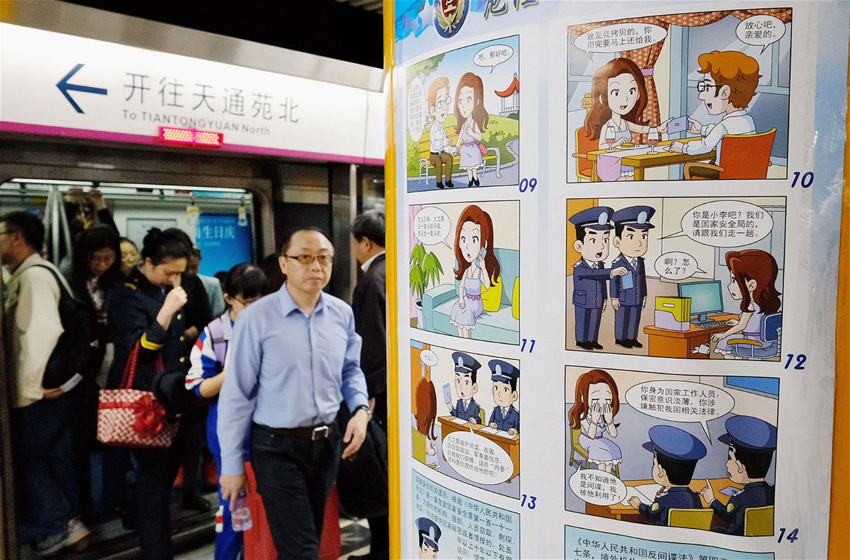 <i>Kyodo/AP/File</i><br/>A comic strip poster warning of foreign spies is displayed at a subway station in Beijing on April 22