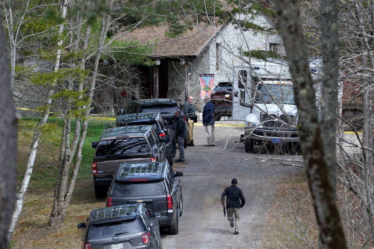 <i>Robert F. Bukaty/AP</i><br/>Investigators work at the scene of a deadly shooting on April 18 in Bowdoin