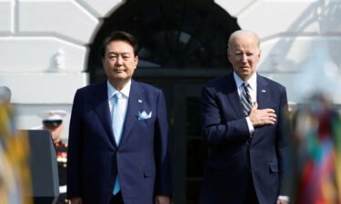 President Joe Biden and South Korea's President Yoon Suk Yeol listen to their countries' national anthems together during an official White House State Arrival Ceremony on the South Lawn of the White House in Washington