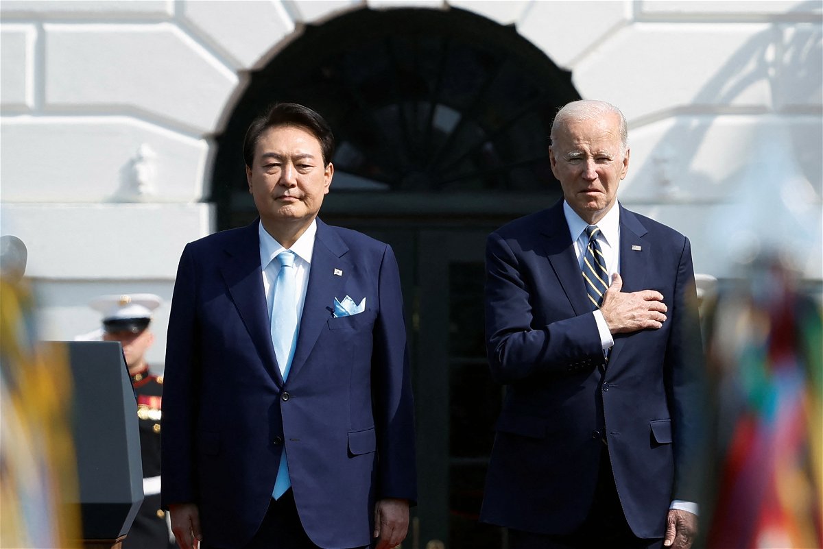 <i>Jonathan Ernst/Reuters</i><br/>President Joe Biden and South Korea's President Yoon Suk Yeol listen to their countries' national anthems together during an official White House State Arrival Ceremony on the South Lawn of the White House in Washington