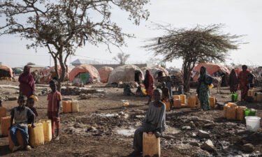 People wait for water at a camp in Baidoa