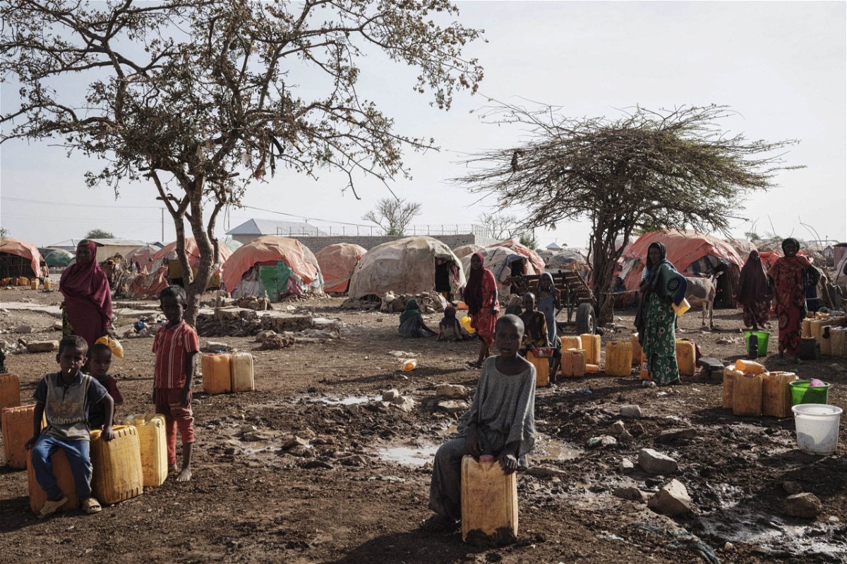 <i>Yasuyoshi Chiba/AFP/Getty Images</i><br/>People wait for water at a camp in Baidoa