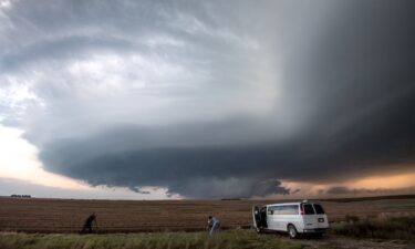 Storm chasing photographers take photos underneath a rotating supercell storm system in Maxwell