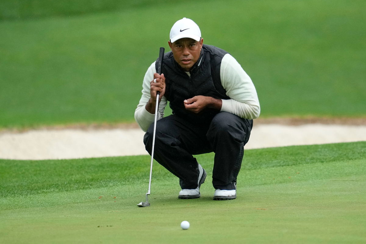 <i>Mark Baker/AP</i><br/>Tiger Woods lines up a putt on the 16th hole during the second round at Augusta.