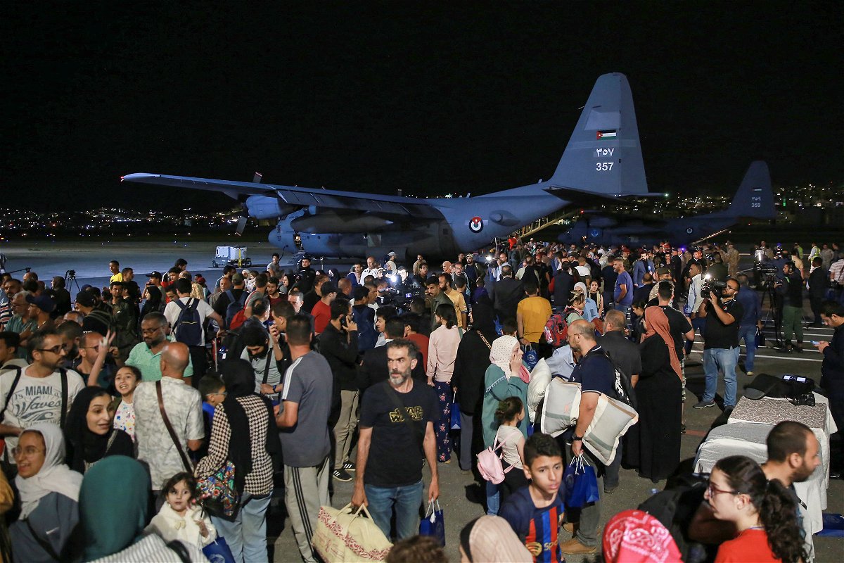<i>Khahil Mazraawi/AFP/Getty Images</i><br/>People evacuated from Sudan arrive at a military airport in Amman Monday