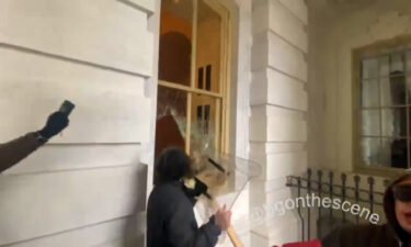 Dominic Pezzola smashes a window with a police riot shield.