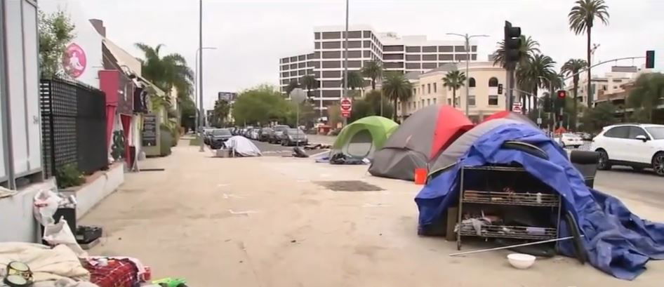 <i></i><br/>A business owner is calling on city officials to take action after reporting a homeless encampment in which a naked woman was seen lying on a couch