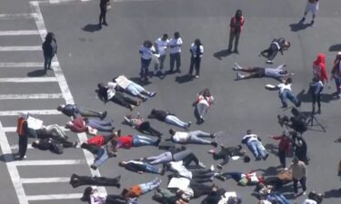 Teens hold a 'die-in' near Washington Street and Columbia Road in Boston to protest gun violence.