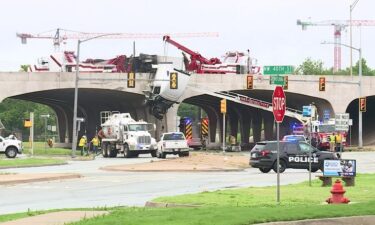 A semi-truck hangs over an Interstate 44 bridge in Oklahoma City