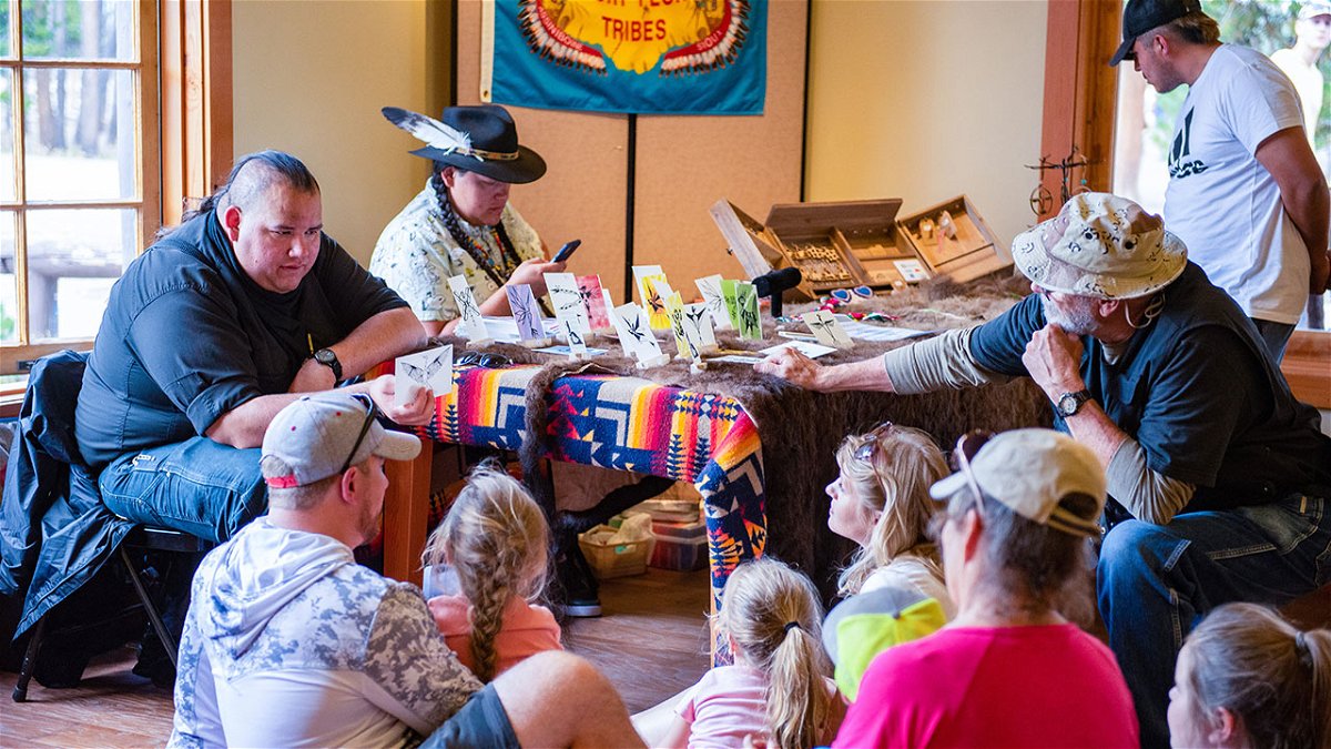 Mason Runs Through (Assiniboine) engaging with Yellowstone Tribal Heritage Center visitors.