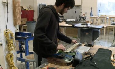 AJ Garduño tunes his self-made electric guitar.