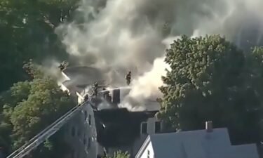 A police officer and an off-duty firefighter helped the residents of a triple-decker house in Somerville
