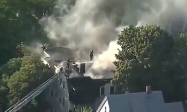 A police officer and an off-duty firefighter helped the residents of a triple-decker house in Somerville