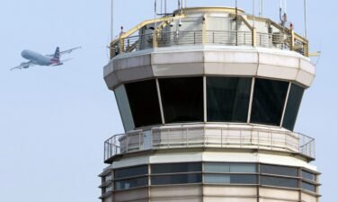 An American Airlines Airbus A319 airplane takes off past the air traffic control tower at Ronald Reagan Washington National Airport in Arlington