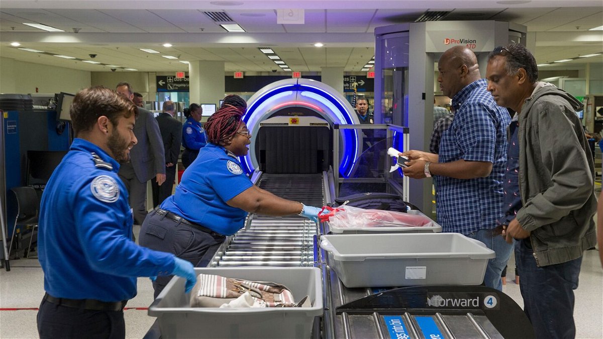 <i>Joe Raedle/Getty Images</i><br/>Transportation Security Administration officers use new Computed Tomography (CT) scanners on bags at Miami International Airport in May. The TSA has announced an expansion of TSA PreCheck access.