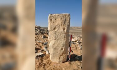 The engraved stone is shown at the JKSH F15 site in Jibal al-Khashabiyeh in Jordan. The monolith was found lying down and was set vertically for the photograph.