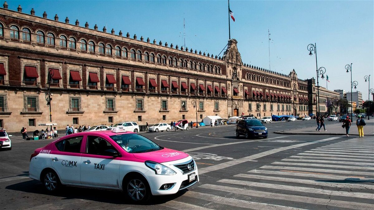 <i>Robert Knopes/Education Images/Universal Images Group/Getty Images</i><br/>A taxi is seen at the National Palace in Mexico City
