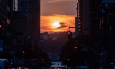 The sun sets while lined up with 42nd Street in Manhattan on July 11