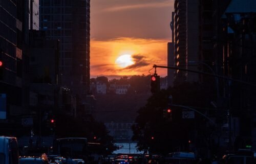 The sun sets while lined up with 42nd Street in Manhattan on July 11